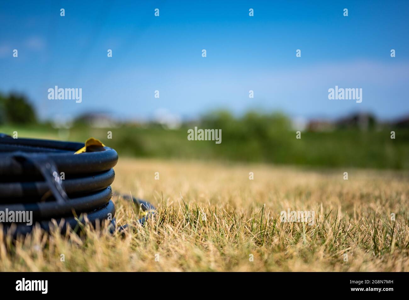 Coil of 1 inch irrigation tubing ready for new installation on top of