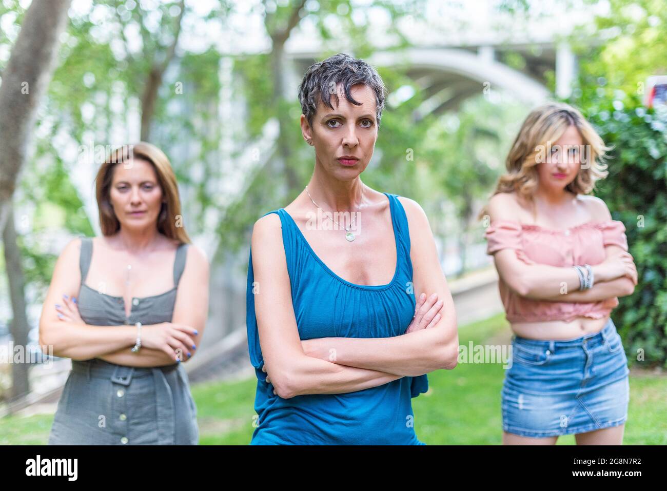 Three serious middle aged women looking at camera with their arms crossed Stock Photo