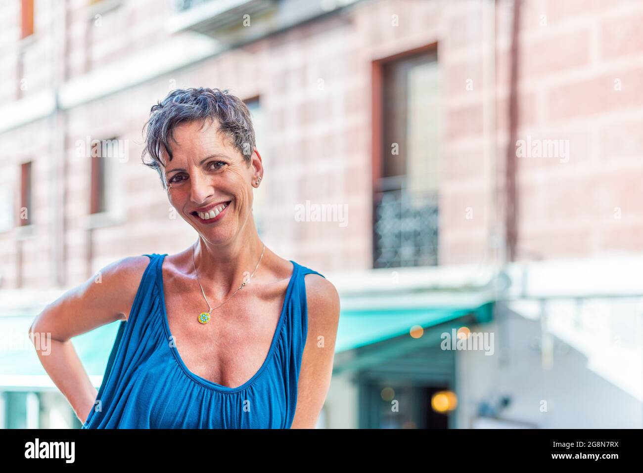 Portrait of a cheerful short hair mature woman on the street looking at camera Stock Photo