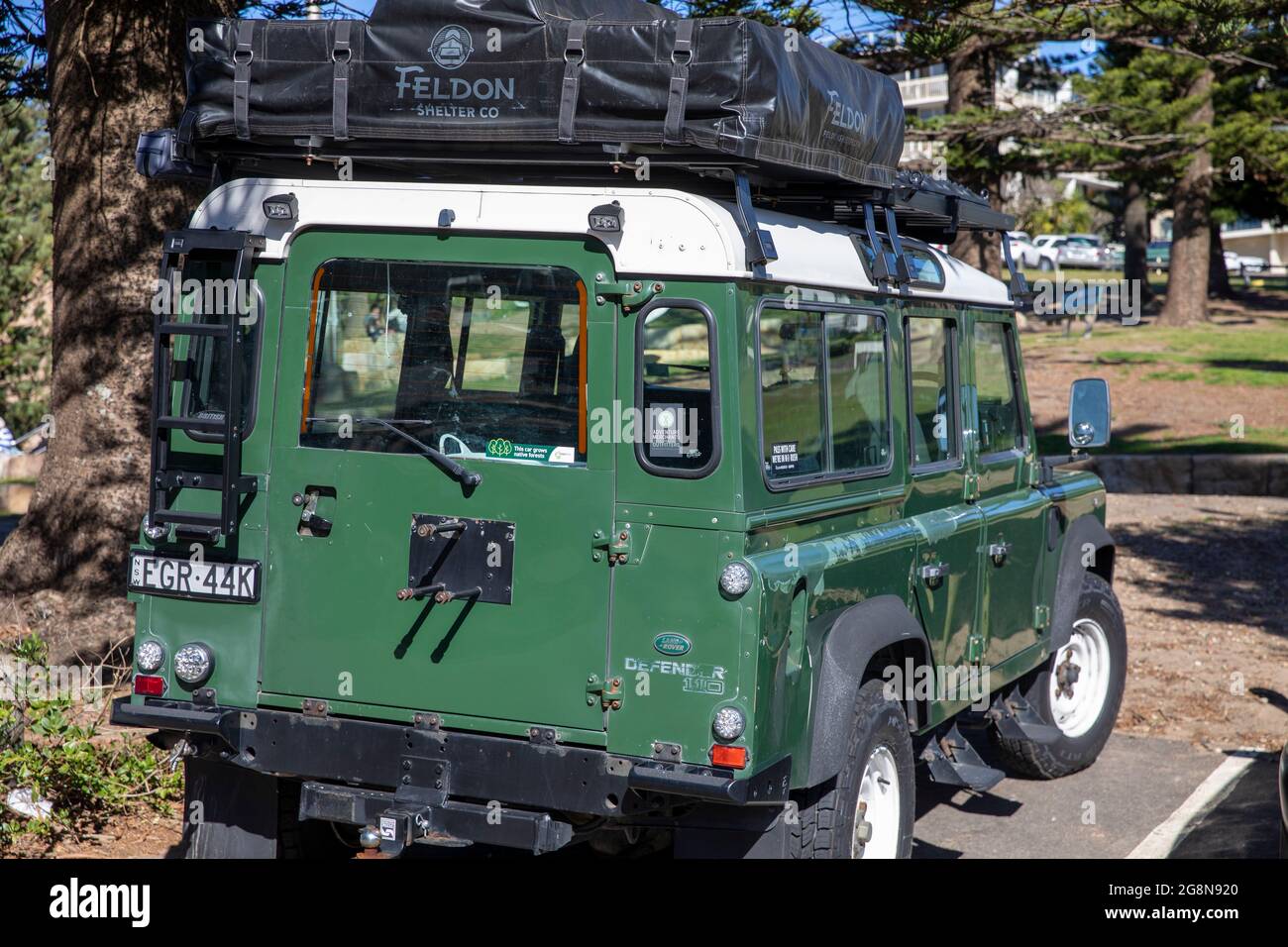 Green Land Rover Defender vehicle with roof rack parked in Sydney,NSW,Australia Stock Photo