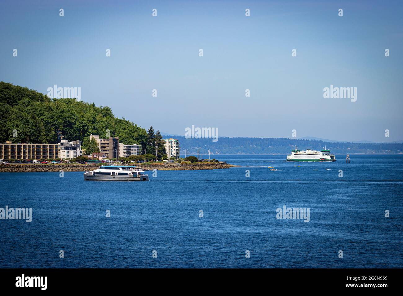 Seattle water taxi and passenger ferry seen together at Alki Point of West Seattle, Washington State, USA. 2021 Stock Photo