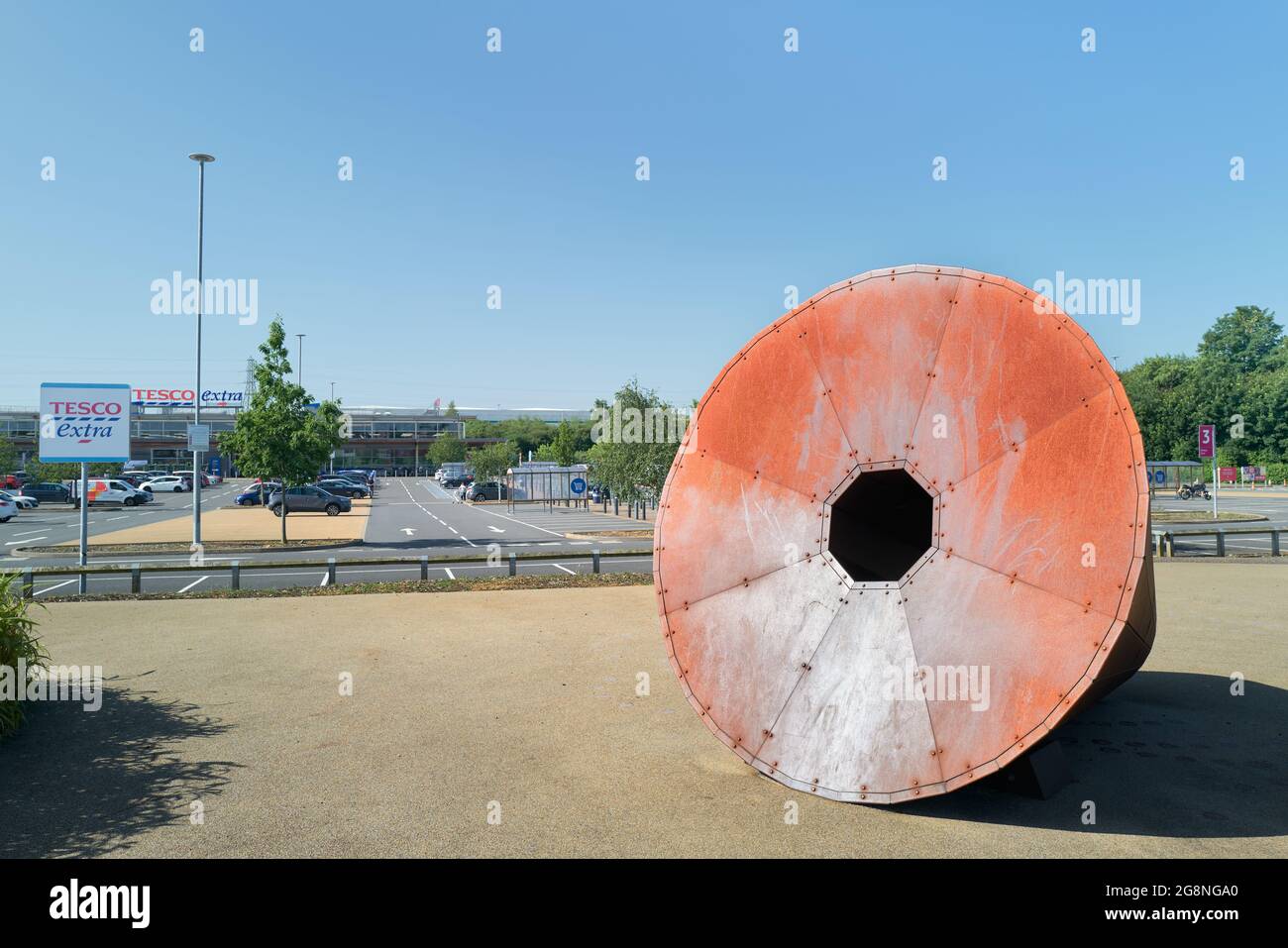 Rusty iron sculpture, reminder of the town's former steel industry, at the Tesco Extra store, Corby, England. Stock Photo