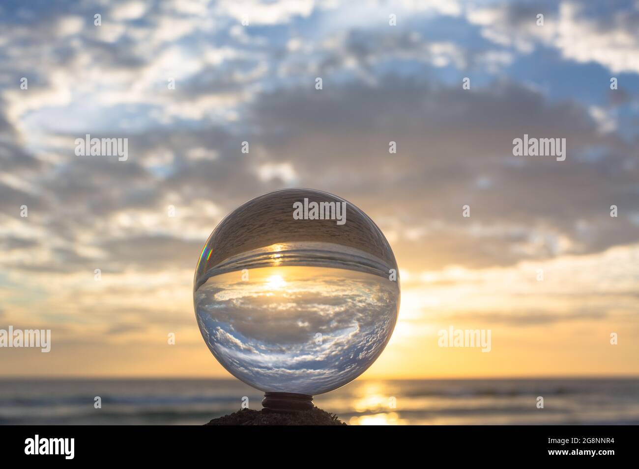 beautiful cloud and golden sunset inside crystal ball placed on a ...