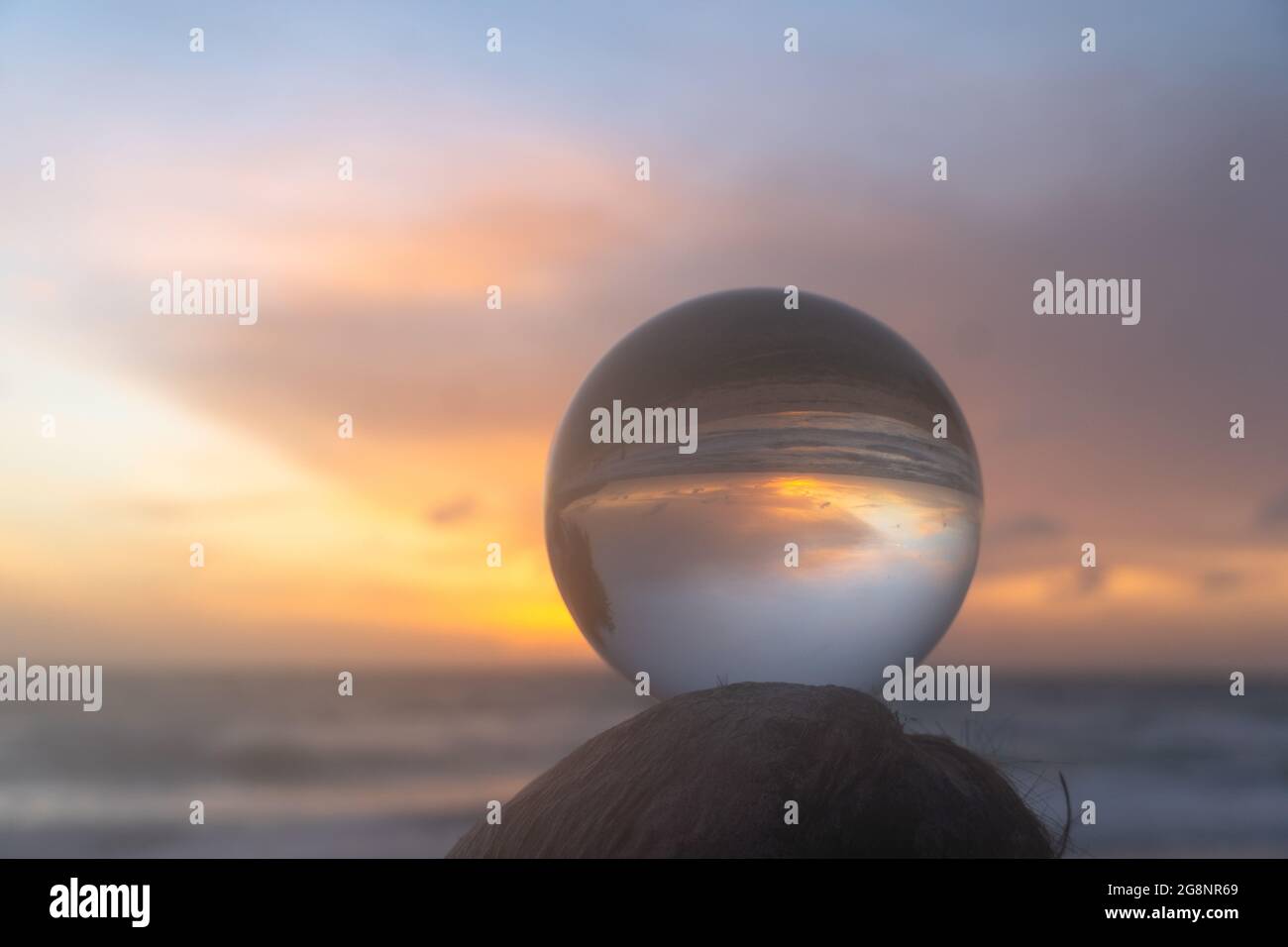 beautiful cloud and golden sunset inside crystal ball placed on a ...