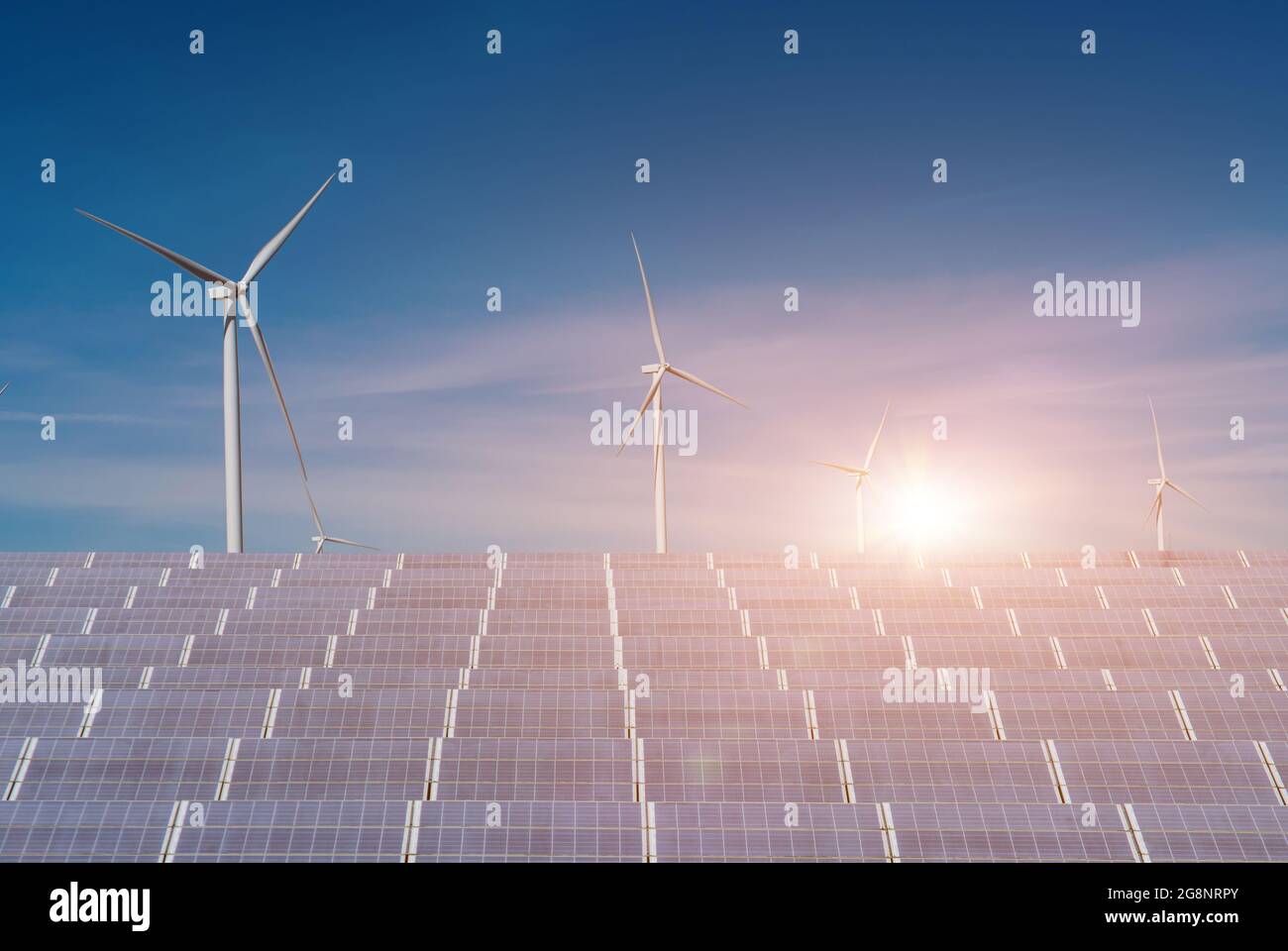 Solar panels with wind turbines against blue sky background. Concept of ...