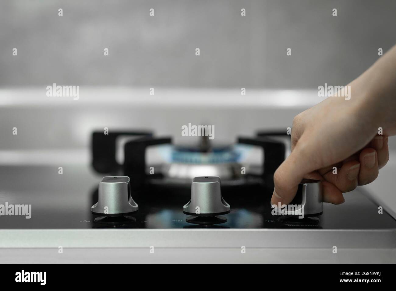 hand turning on gas stove Stock Photo Alamy