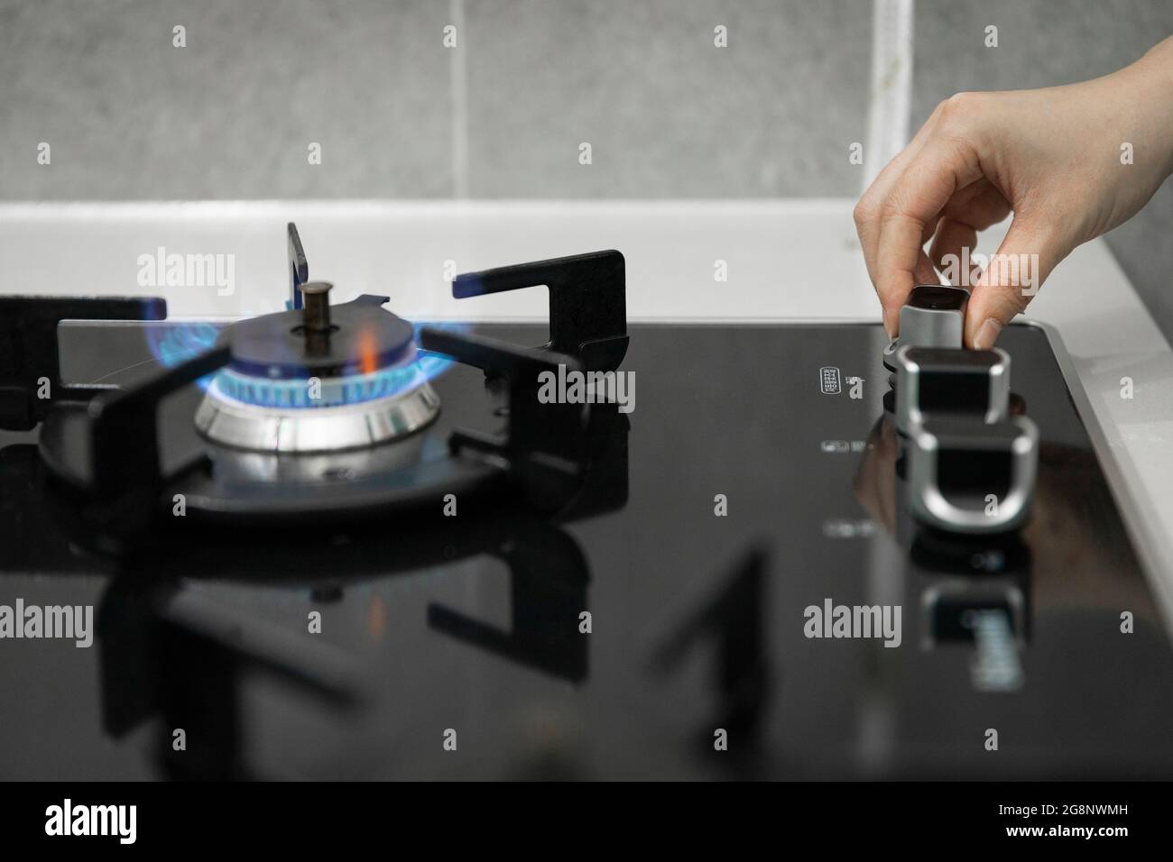 hand turning on gas stove Stock Photo Alamy