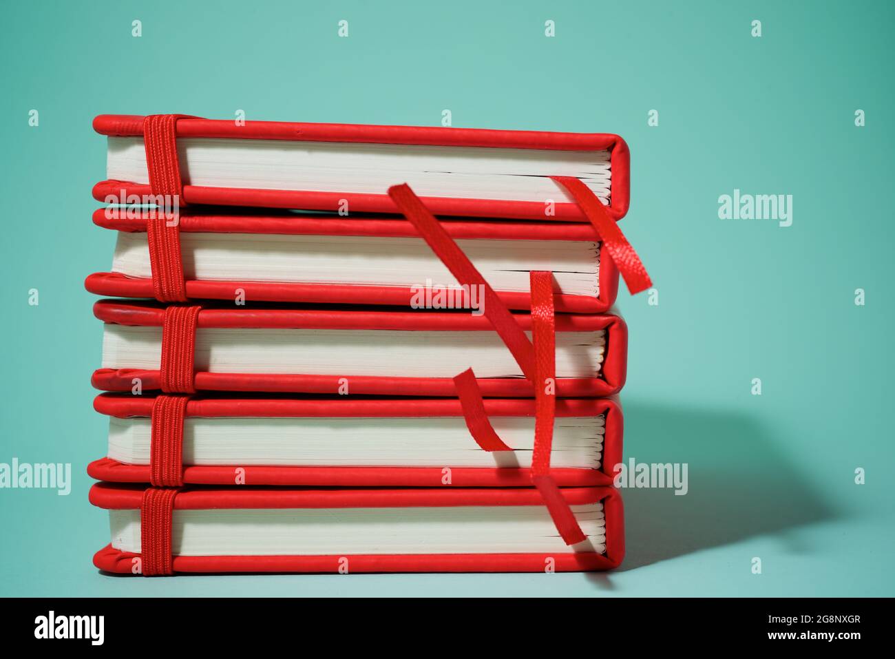 Red notebook on a green table. Stock Photo