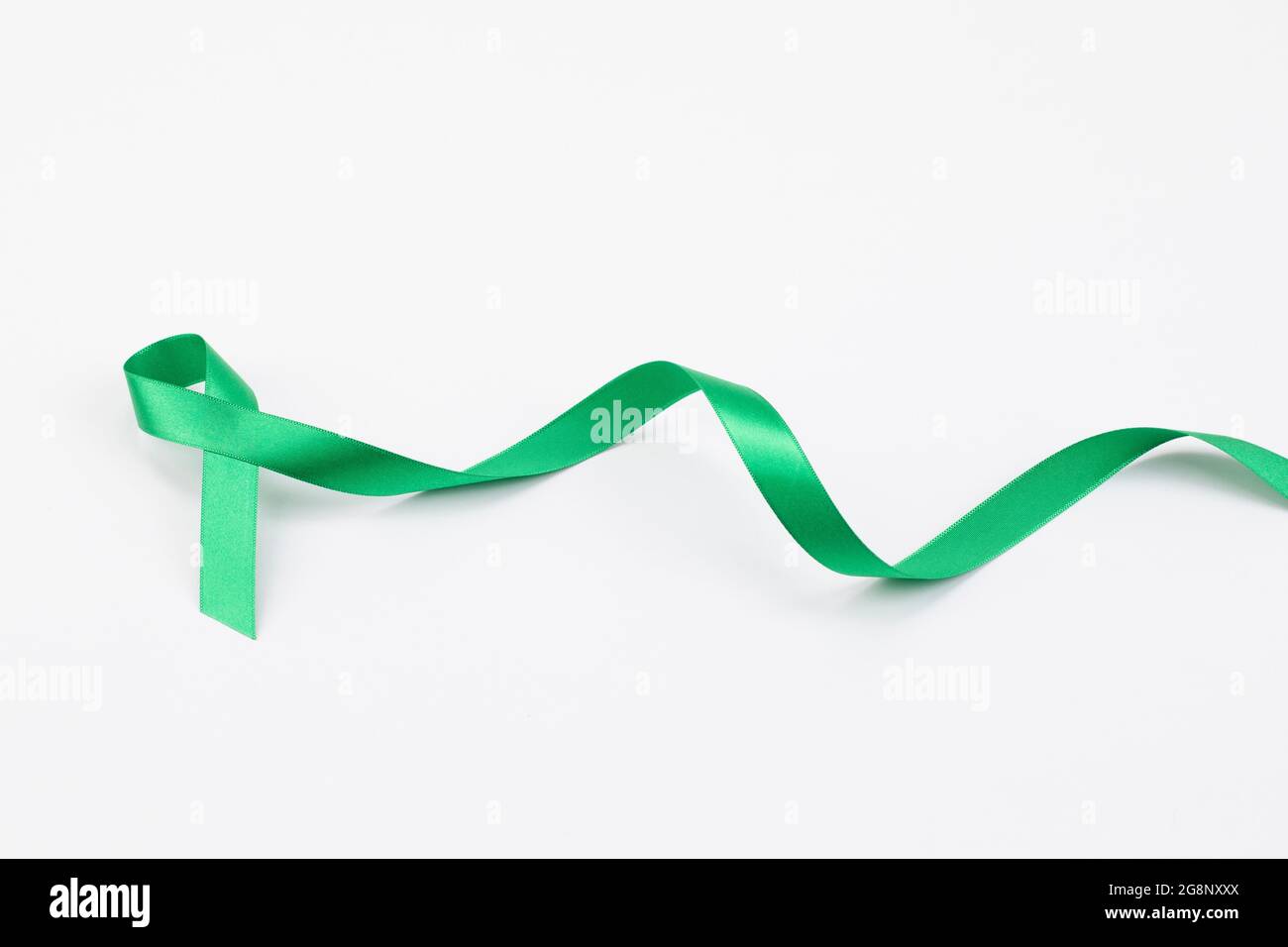green ribbon on white background Stock Photo - Alamy