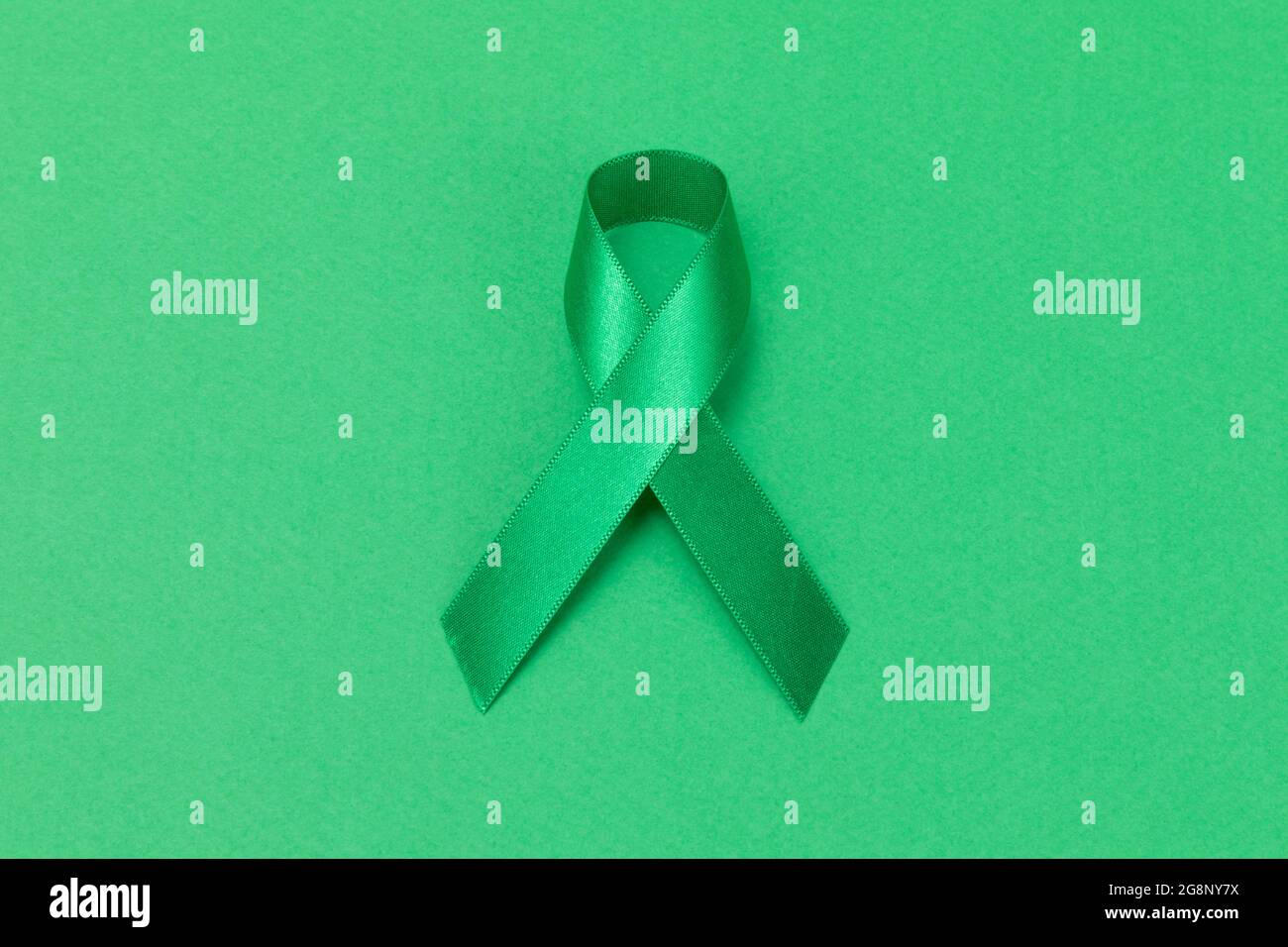 green ribbon on green background Stock Photo - Alamy