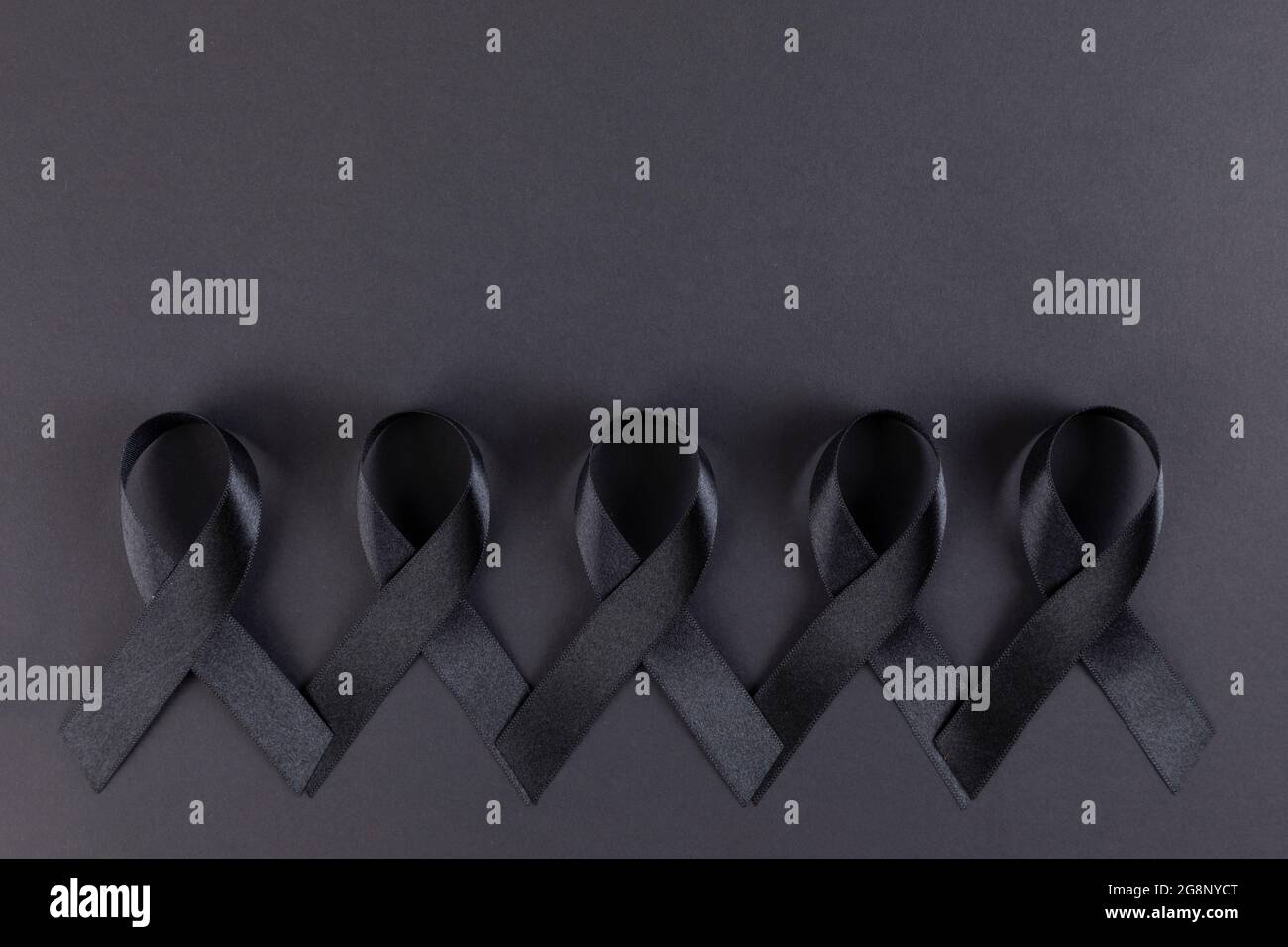 Black ribbons on black background Stock Photo - Alamy