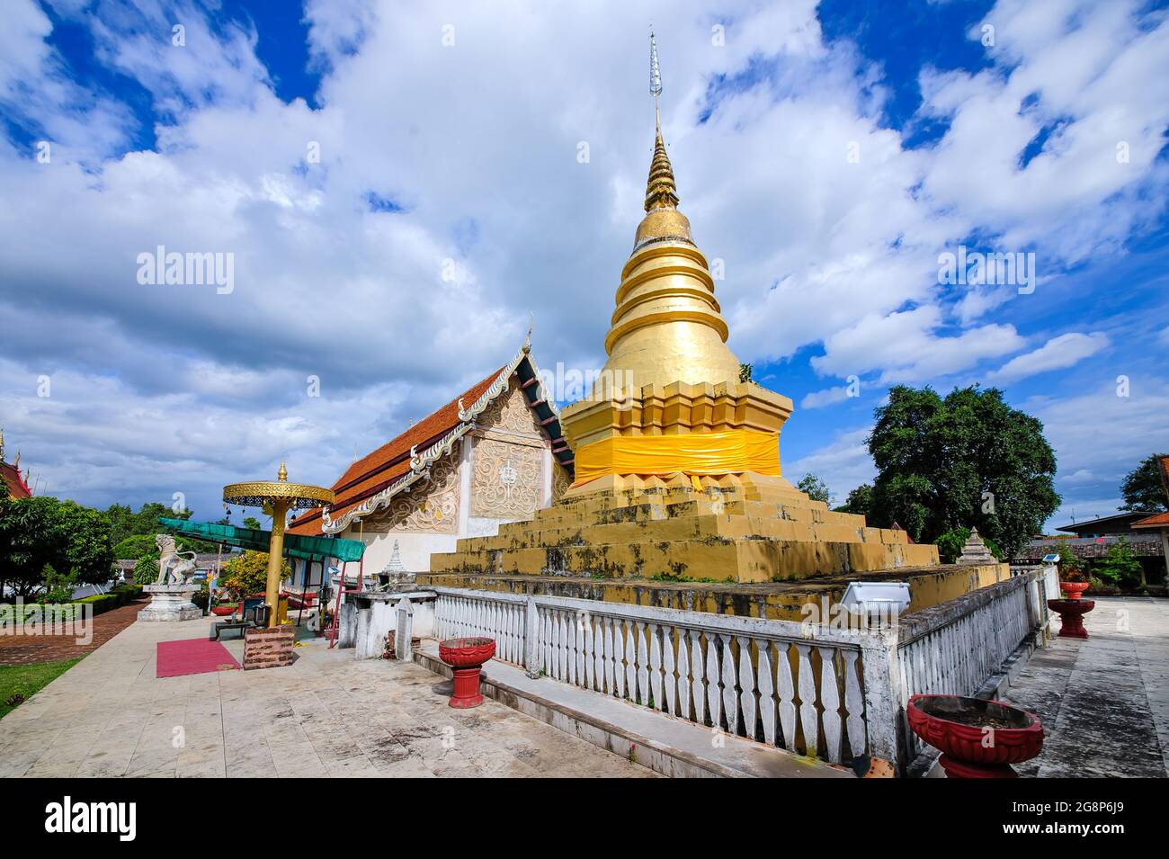 golden pagodas and temple building with blue cloudy sky in background ...