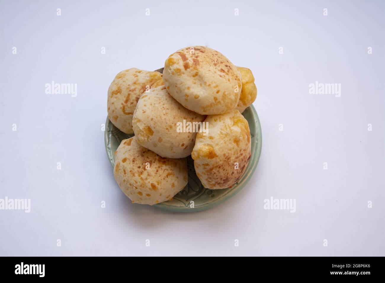 Top view of delicious loaves of chipa bread from Paraguay on a clay plate in a bright kitchen Stock Photo