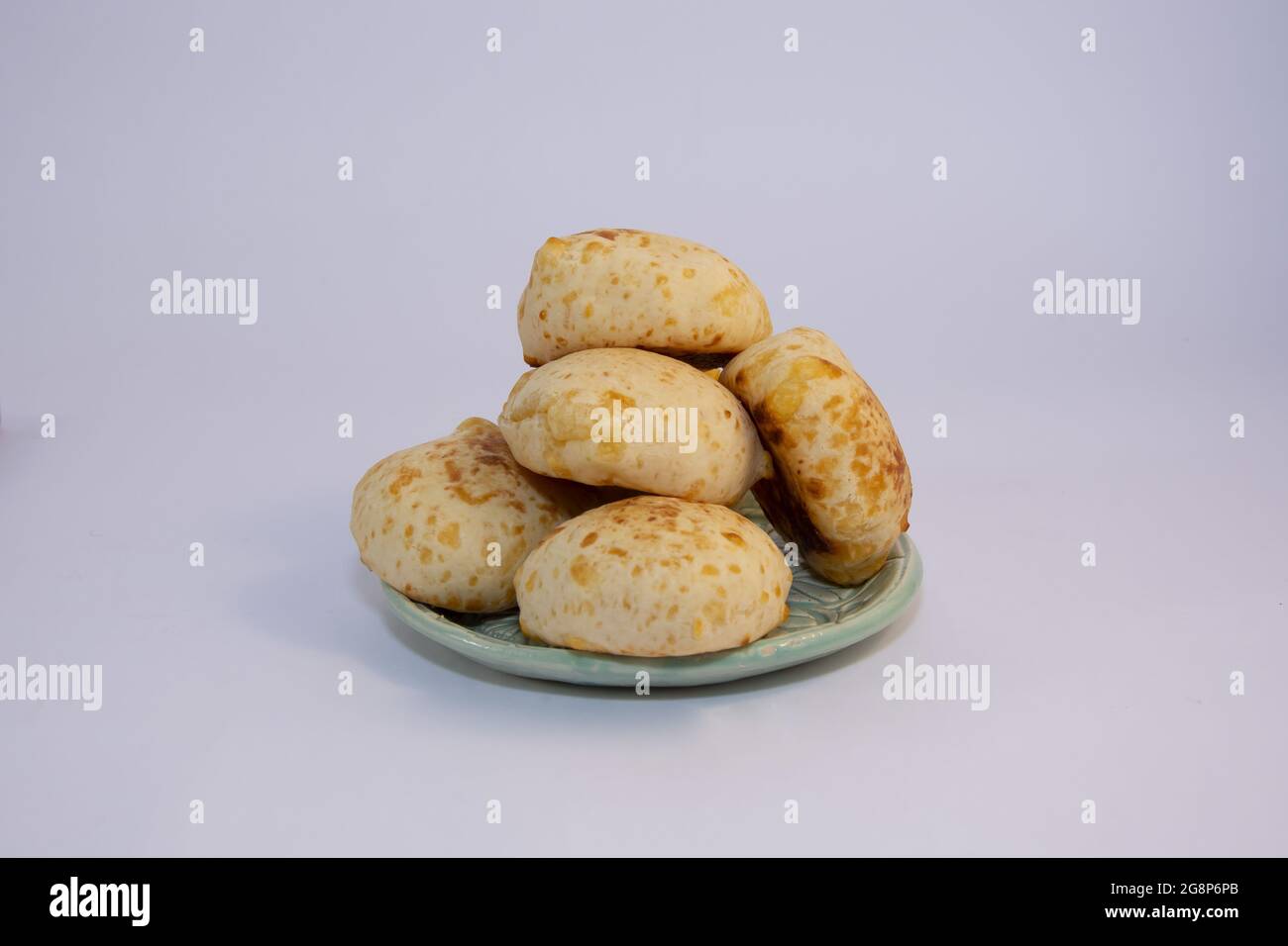 Closeup of delicious Chipa bread from Paraguay on a clay plate in a bright kitchen Stock Photo