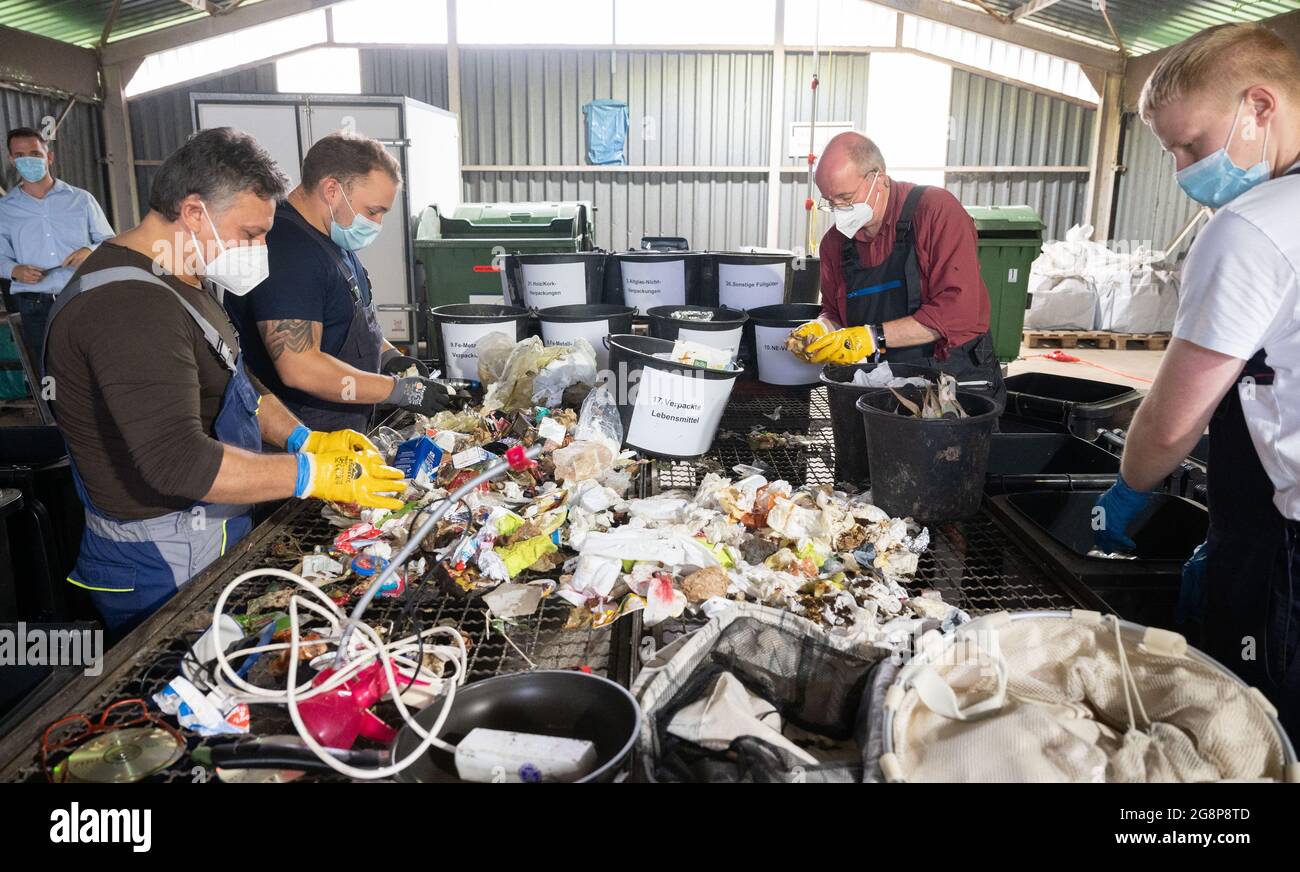 Hanover, Germany. 22nd July, 2021. Employees sort residual waste by hand at  a press conference at the Lahe landfill site of aha Zweckverband  Abfallwirtschaft Region Hannover. The waste disposal company aha presents