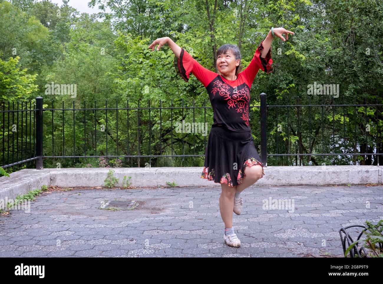 Posed photo of a very graceful Chinese American dancer. In Kissena Park in Flushing, Queens, New York City. Stock Photo