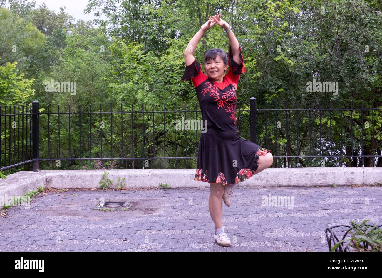 Posed photo of a very graceful Chinese American dancer. In Kissena Park in Flushing, Queens, New York City. Stock Photo