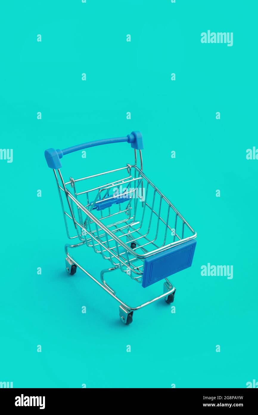 supermarket trolley on blue background Stock Photo