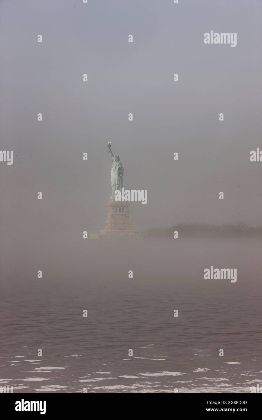 The Statue of Liberty in the fog, Liberty Island, New York City, New York, USA Stock Photo