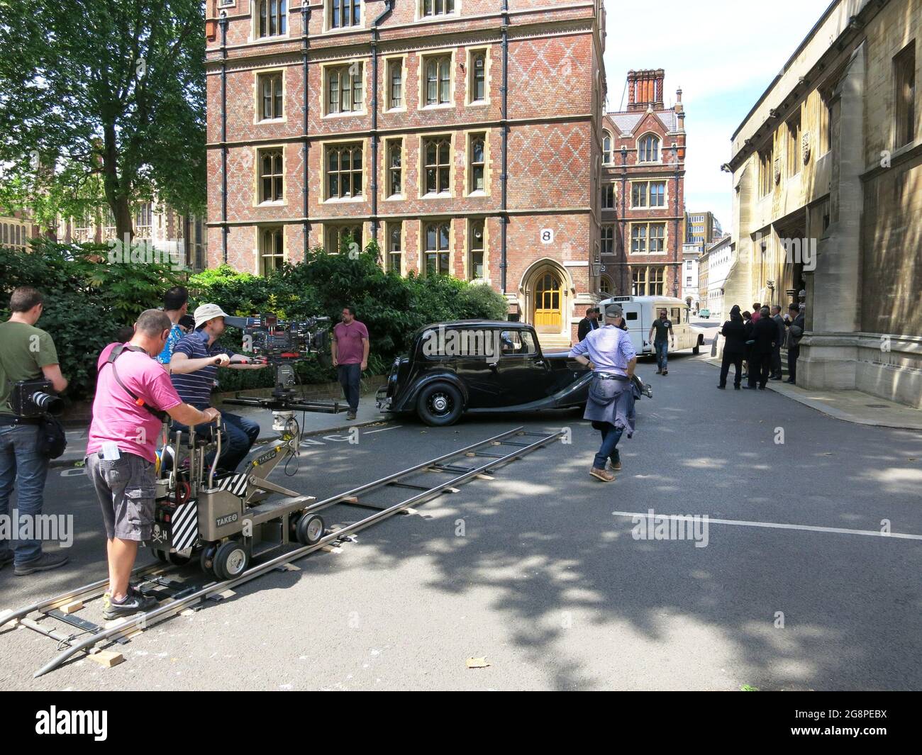 Film Crew at Work on Location Setting op a Tracking Shot. Stock Photo