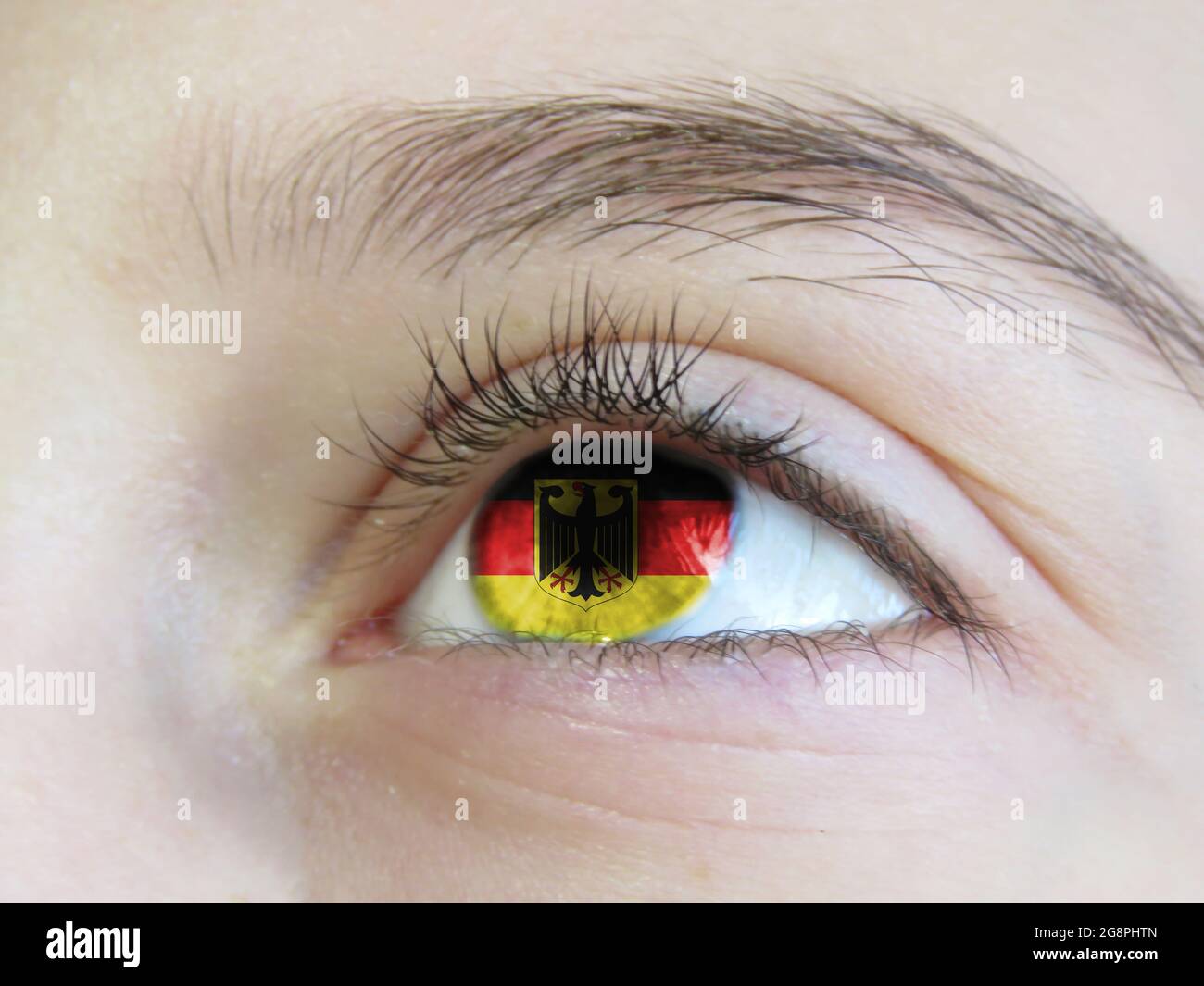 Portrait of a young girl with the color of the eyes of the flag of Germany  Stock Photo - Alamy
