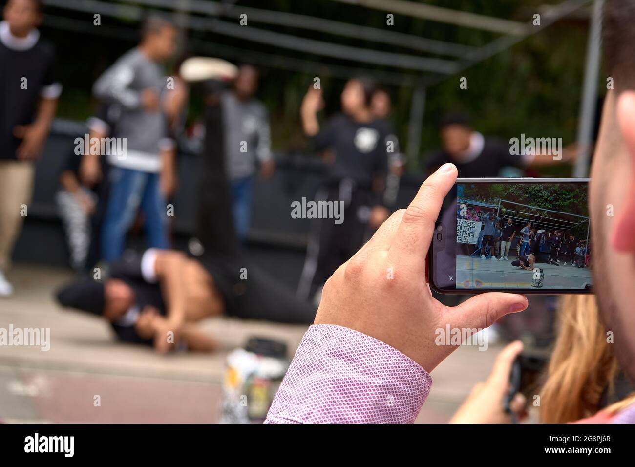 MEDELLI, COLOMBIA - Nov 30, 2019: A young man recording the street dance performance in Medellin, Colombia Stock Photo