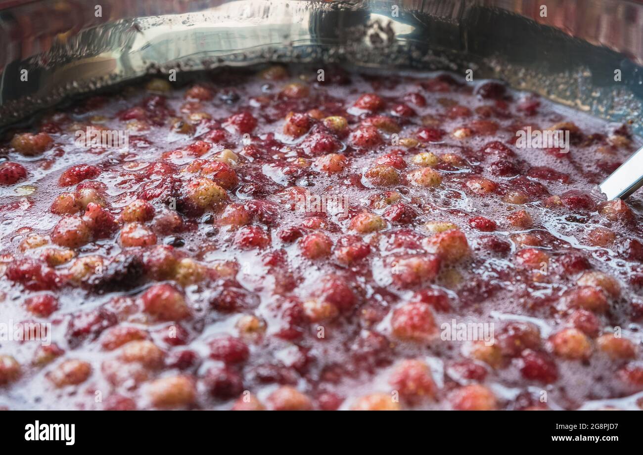 bowl full with homemade wild strawberry jam berries soaked in sugar syrup Stock Photo