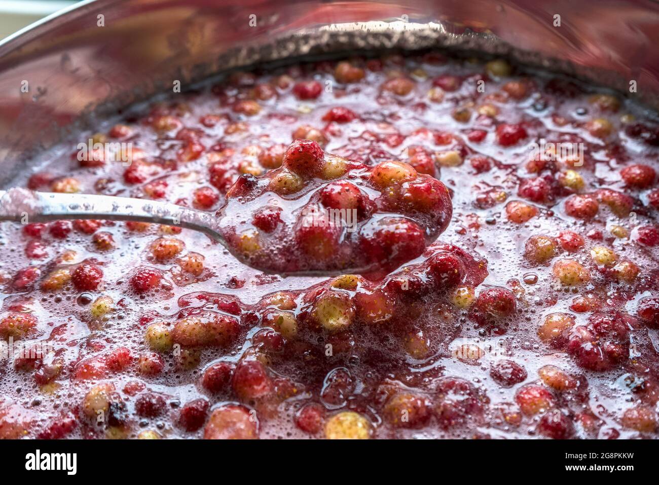 spoon full with freshly homemade strawberry jam Stock Photo