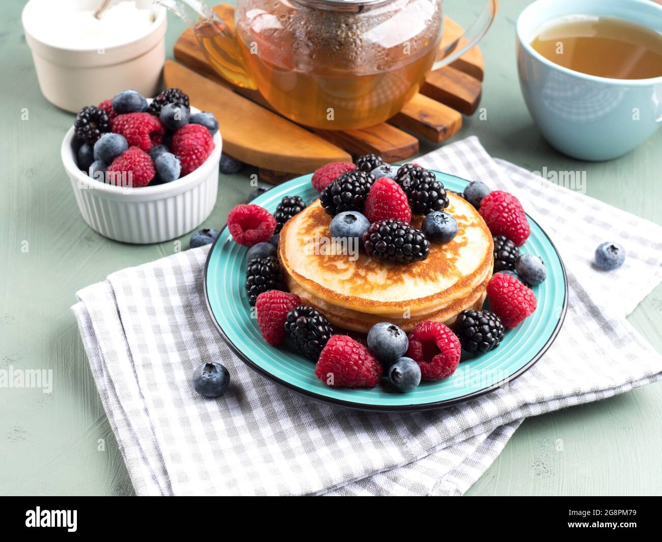 Pancakes Raspberry Blueberries Mint Stack of pancakes with raspberries and blueberries served with green ...