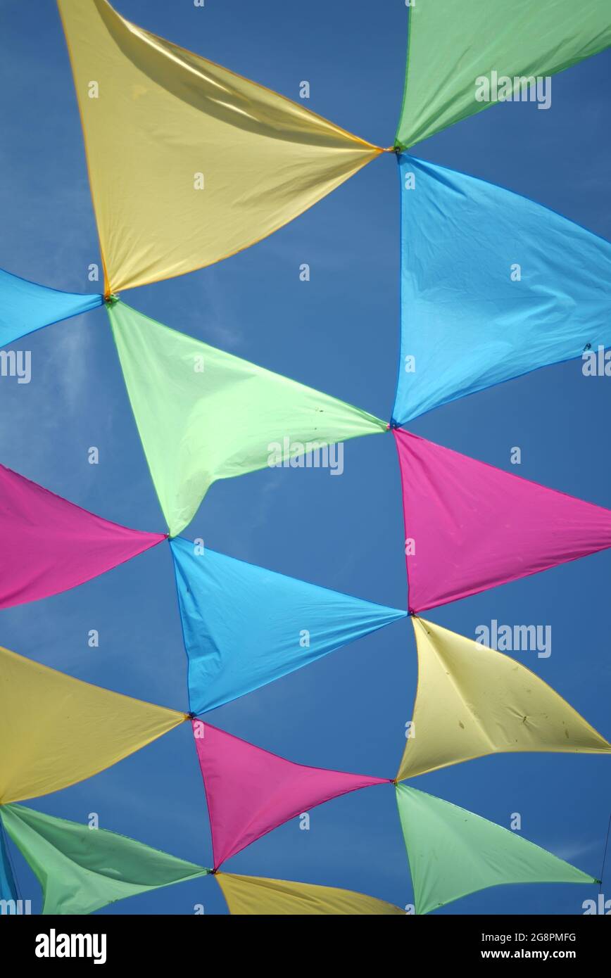 Coloured triangular bunitng floating in the clear blue sky Stock Photo