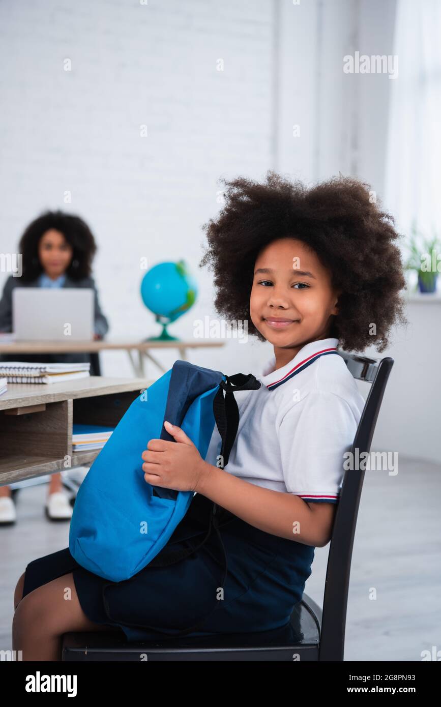 kid holding backpack
