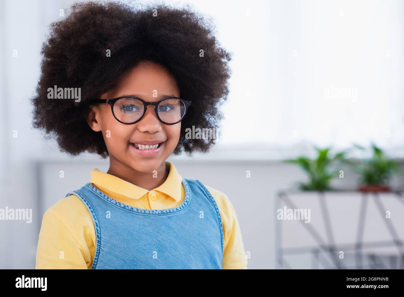 Smiling african american kid in eyeglasses looking at camera Stock ...