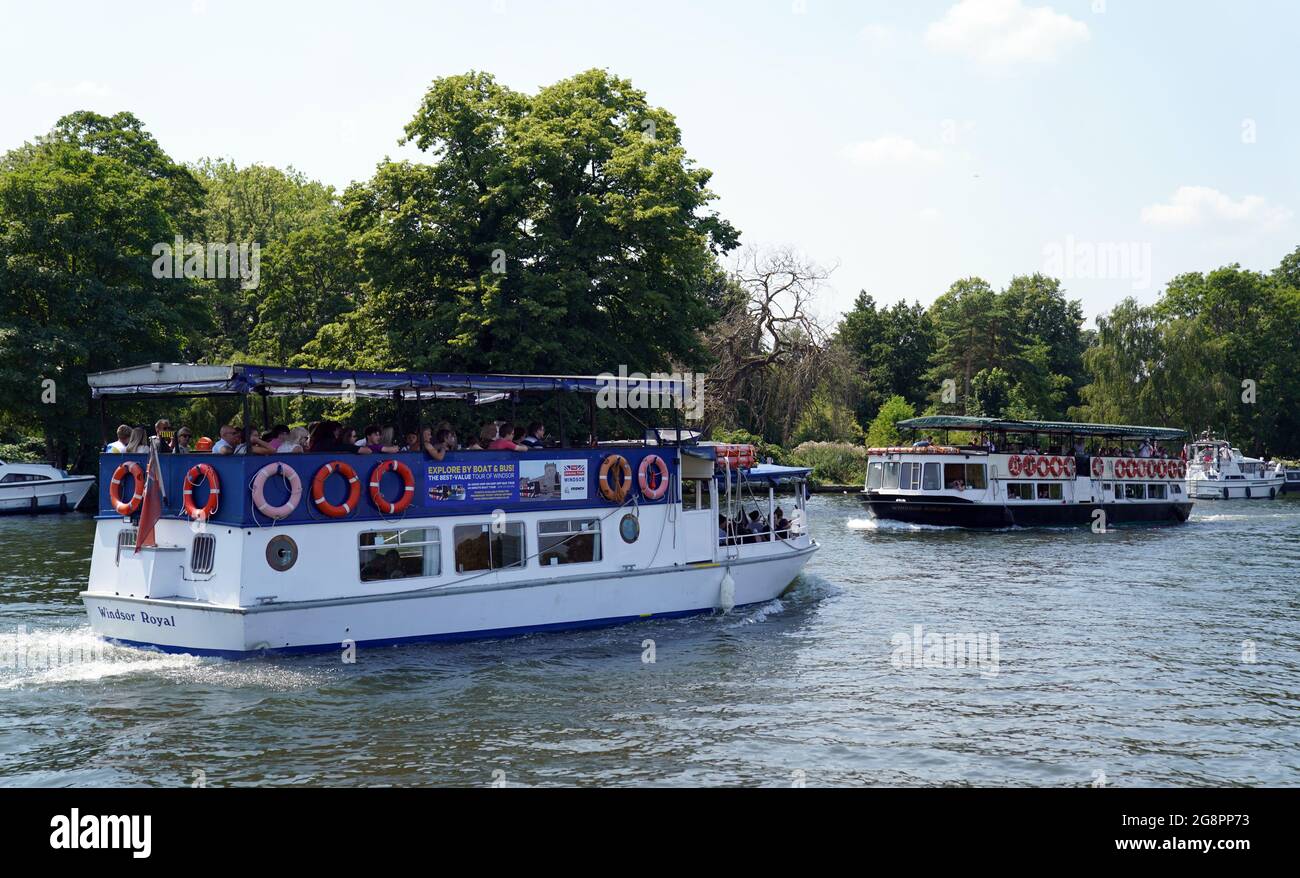 People in boats on the River Thames in Windsor, Berkshire. A heatwave which has baked the UK over the last few days is expected to end with thunderstorms across much of England and Wales this weekend, forecasters have warned. Picture date: Thursday July 22, 2021. Stock Photo