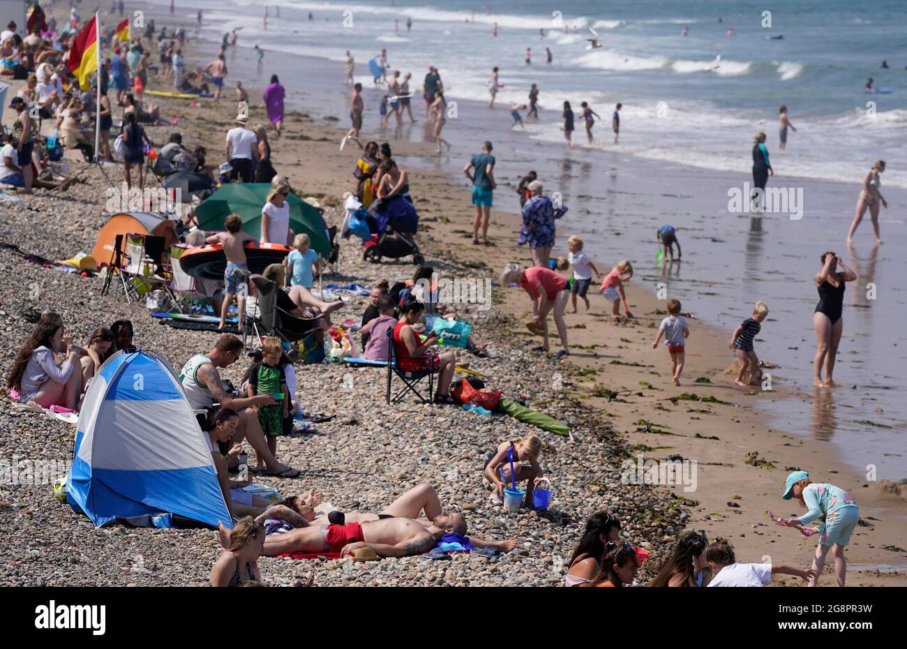 People on the beach at Saltburn-by-the-Sea in North Yorkshire. A heatwave which has baked the UK over the last few days is expected to end with thunderstorms across much of England and Wales this weekend, forecasters have warned. Picture date: Thursday July 22, 2021. Stock Photo