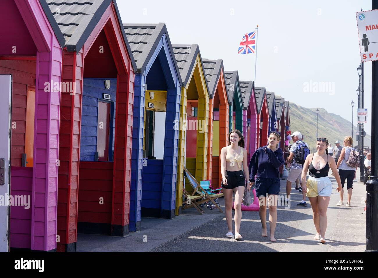 People on the beach at Saltburn-by-the-Sea in North Yorkshire. A heatwave which has baked the UK over the last few days is expected to end with thunderstorms across much of England and Wales this weekend, forecasters have warned. Picture date: Thursday July 22, 2021. Stock Photo