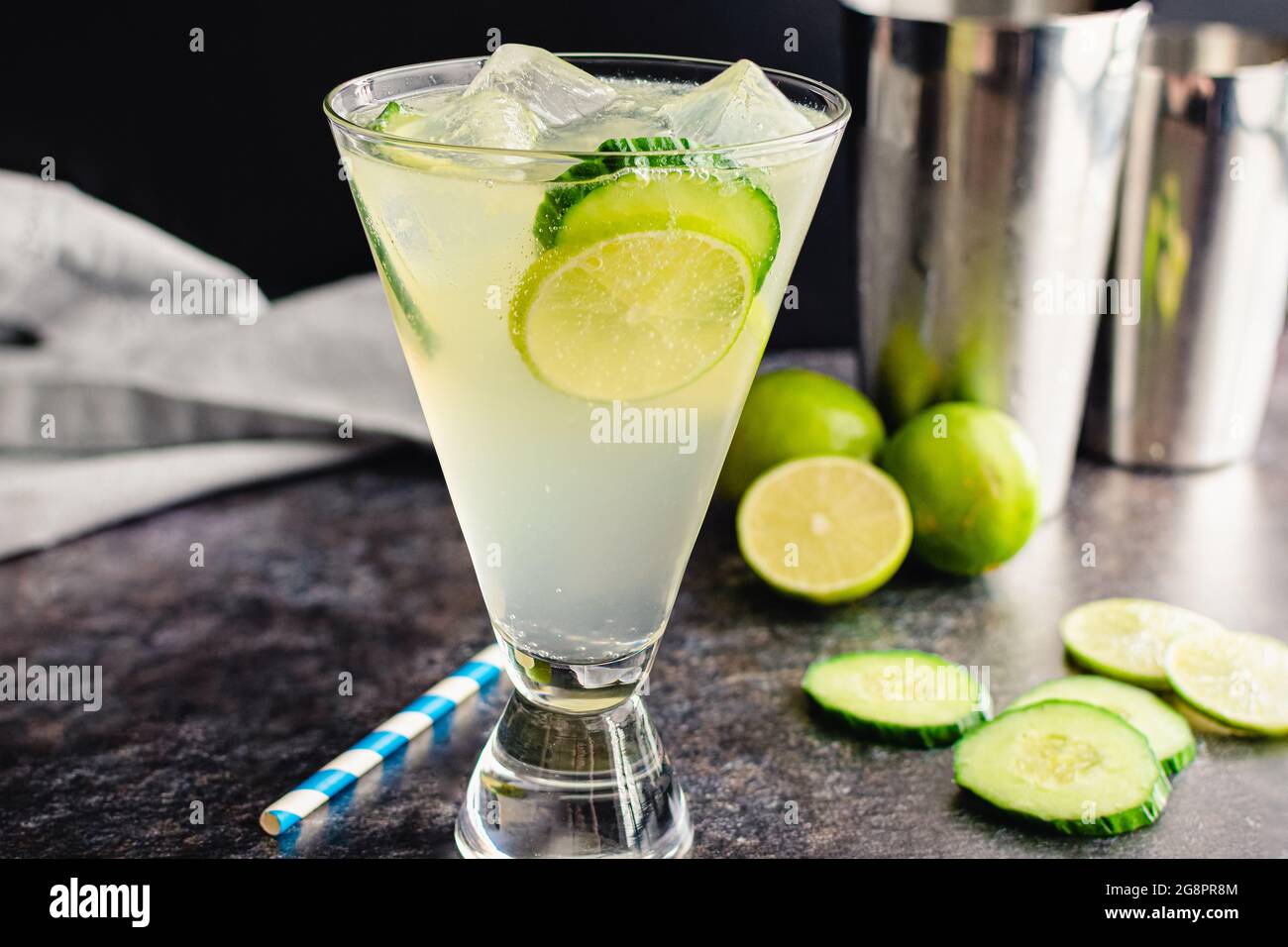 White Linen Cocktail with Cucumber and Lime Garnish: A gin cocktail made with elderflower liqueur and lime juice Stock Photo
