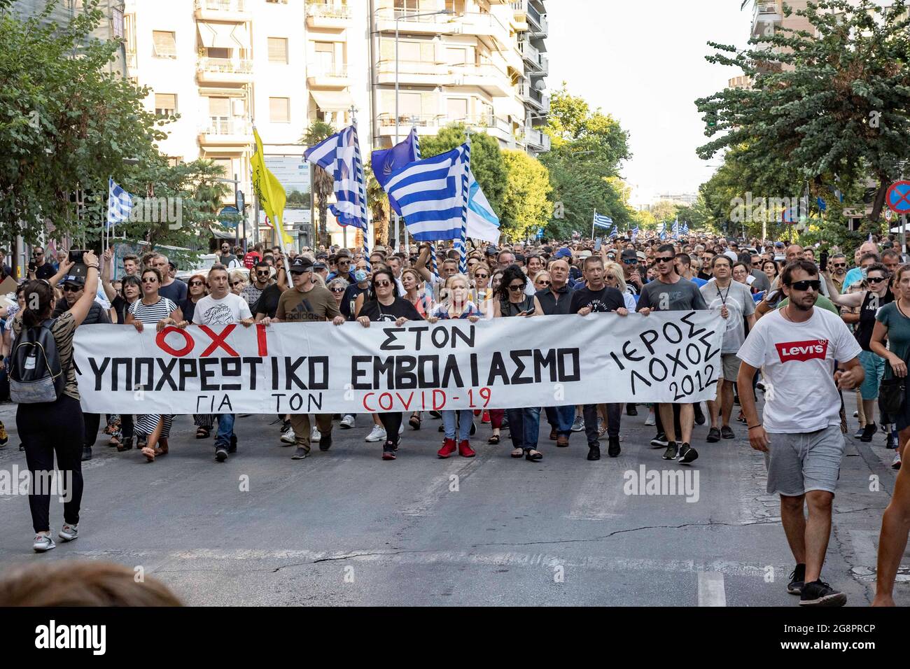 Thessaloniki, Greece. 21st July, 2021. Protesters march while holding flags  and a banner reading "No to the Mandatory Vaccine during the  protest.Thousands of anti-vaccination demonstrators march through  Thessaloniki in demonstration against the