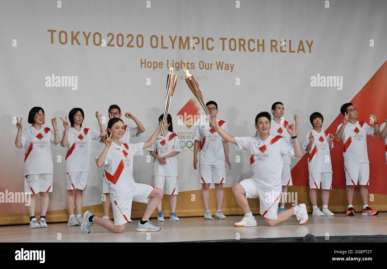 Tokyo, Japan. 22nd July, 2021. Torchbearers pose for the cameras during the Tokyo 2020 Olympic torch relay at Shiba Park in Tokyo, Japan on Thursday, July 22, 2021. Photo by Keizo Mori/UPI Credit: UPI/Alamy Live News Stock Photo