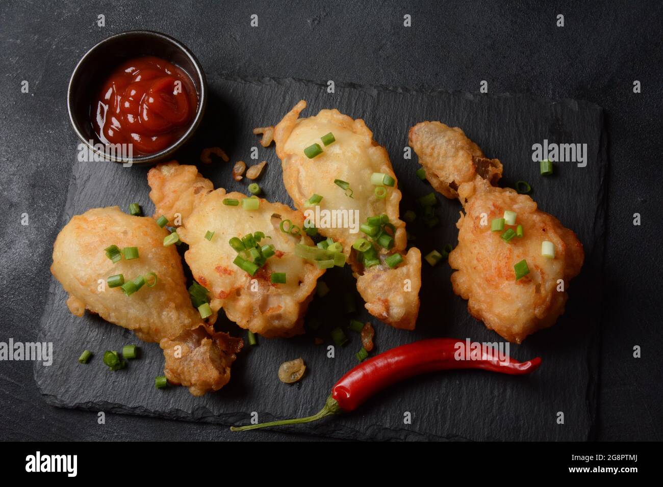 Golden crispy fried chicken drumsticks. Fried chicken pieces lightly