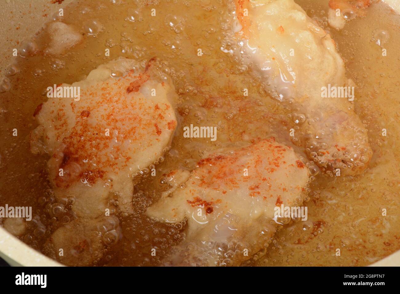 Cooking chicken drumsticks in batter. Deep fried food Stock Photo Alamy
