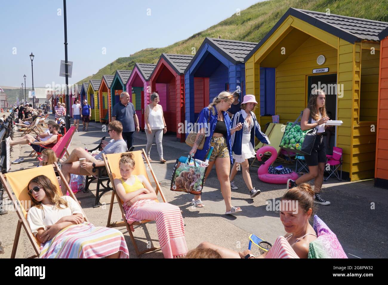 People by the beach at Saltburn-by-the-Sea in North Yorkshire. A heatwave which has baked the UK over the last few days is expected to end with thunderstorms across much of England and Wales this weekend, forecasters have warned. Picture date: Thursday July 22, 2021. Stock Photo