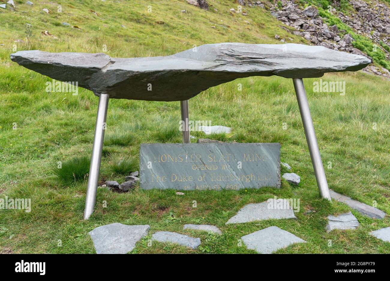 Green slate tablet with shelter commemorating opening by the Duke of Edinburgh of the Honister Slate Mine in the Lake District Cumbria UK Stock Photo