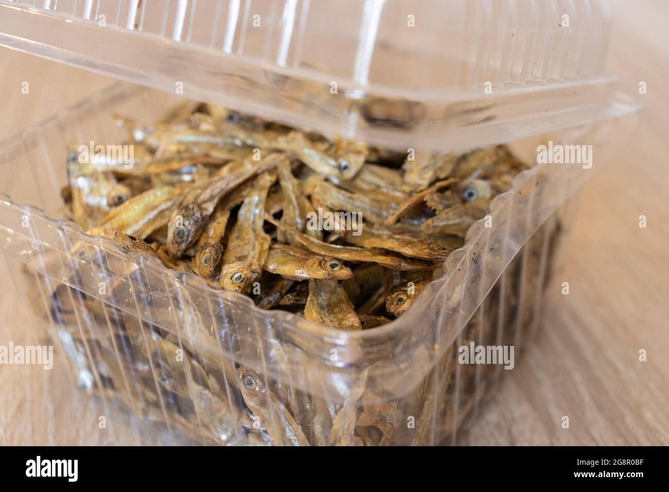 Closeup of dry charales inside of transparent food blister. Dried charales. Dried fish on blister. Stock Photo