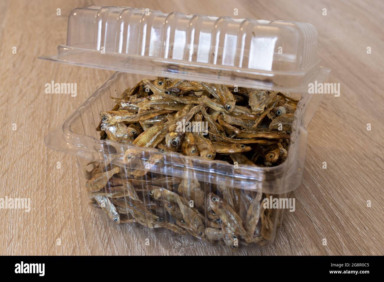 Top view of dry charales inside of transparent food blister. Dried charales. Dried fish on blister. Stock Photo