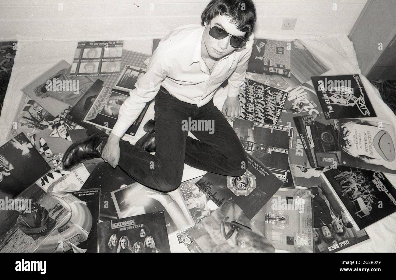 A young man in his early twenties poses with his vinyl record collection circa 1980 in London, England. Stock Photo