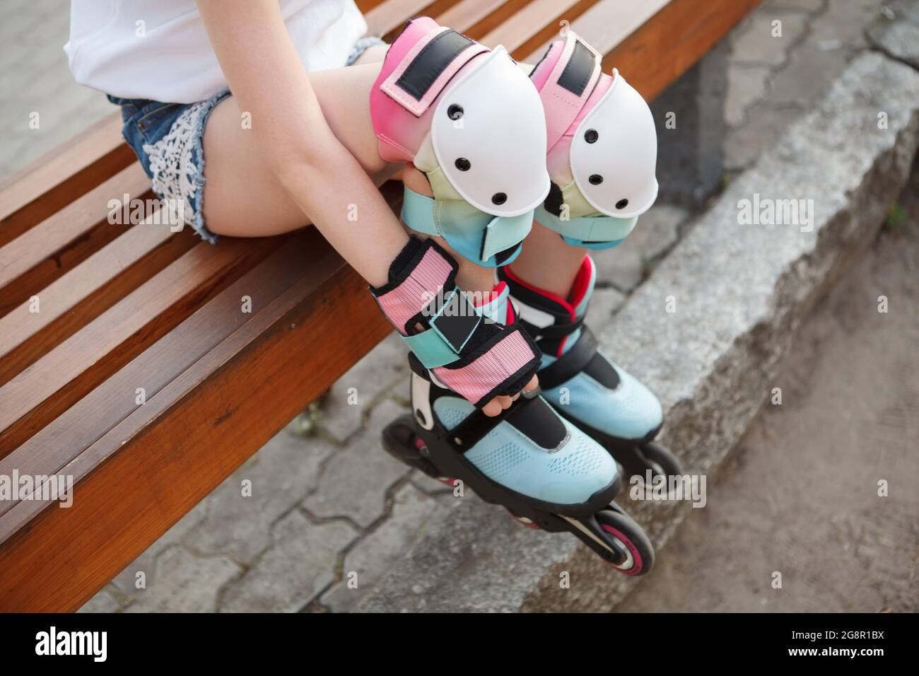Cropped shot of unrecognizable girl wearing colorful knee pads and  rollerblades Stock Photo - Alamy