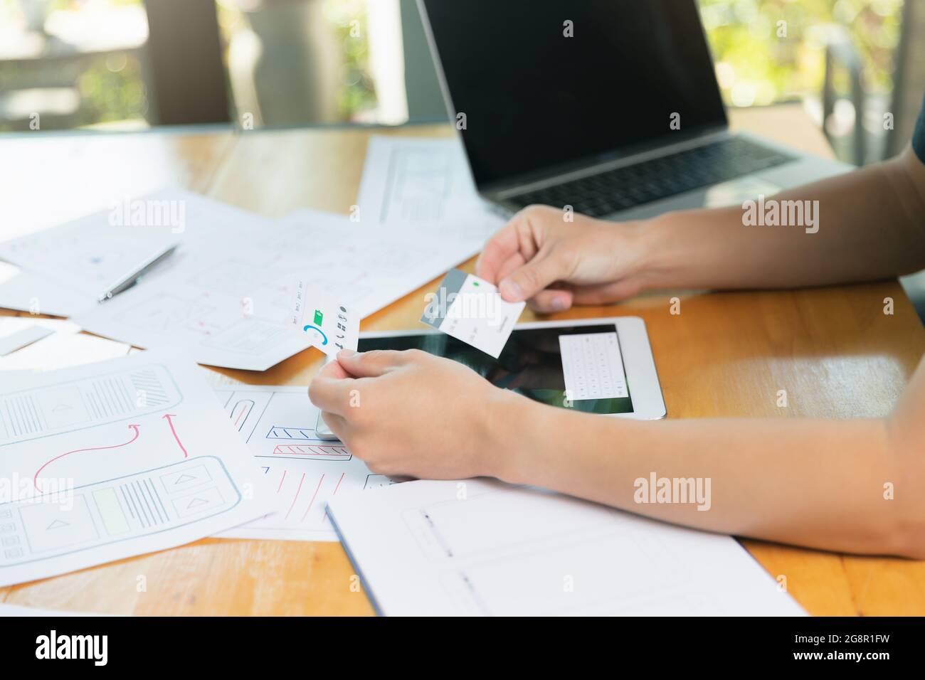 UX or UI designers designing on digital tablet and smartphone ...