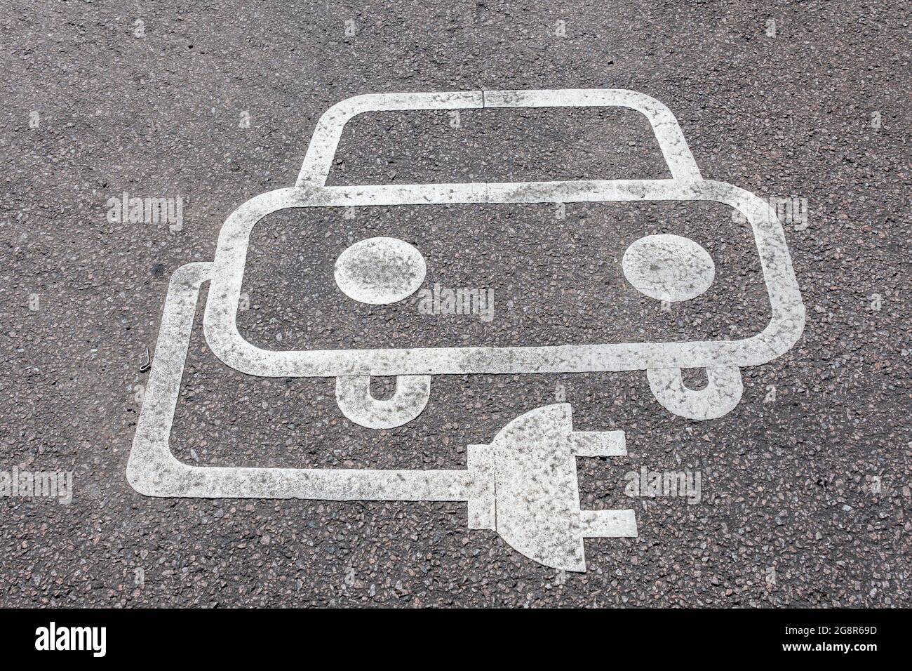 Parking bay for recharging electric vehicles only painted sign on the tarmac Stock Photo