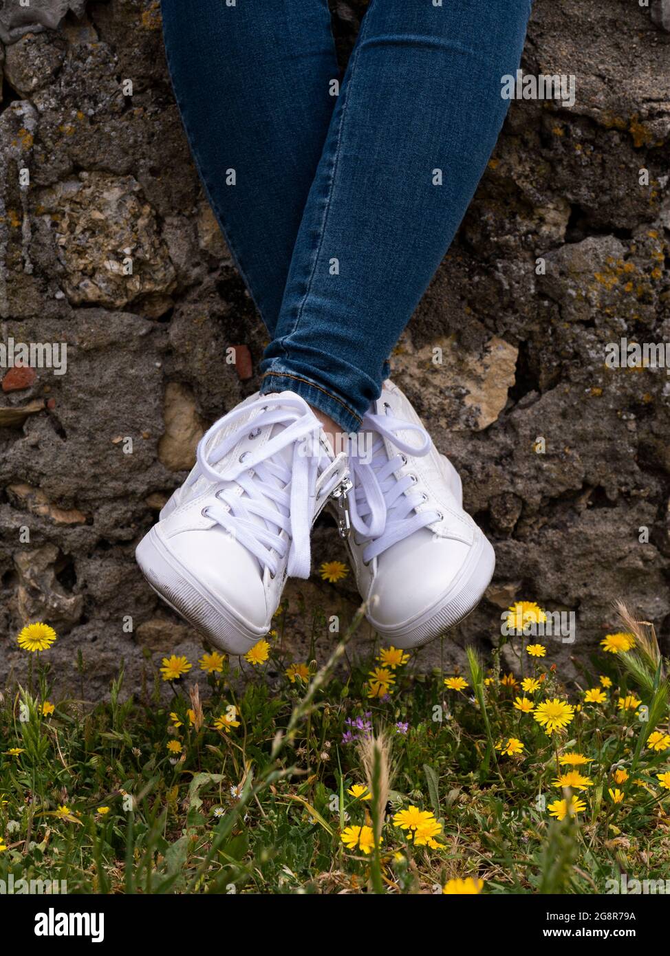 Woman wearing clean white women's shoes sneakers Stock Photo
