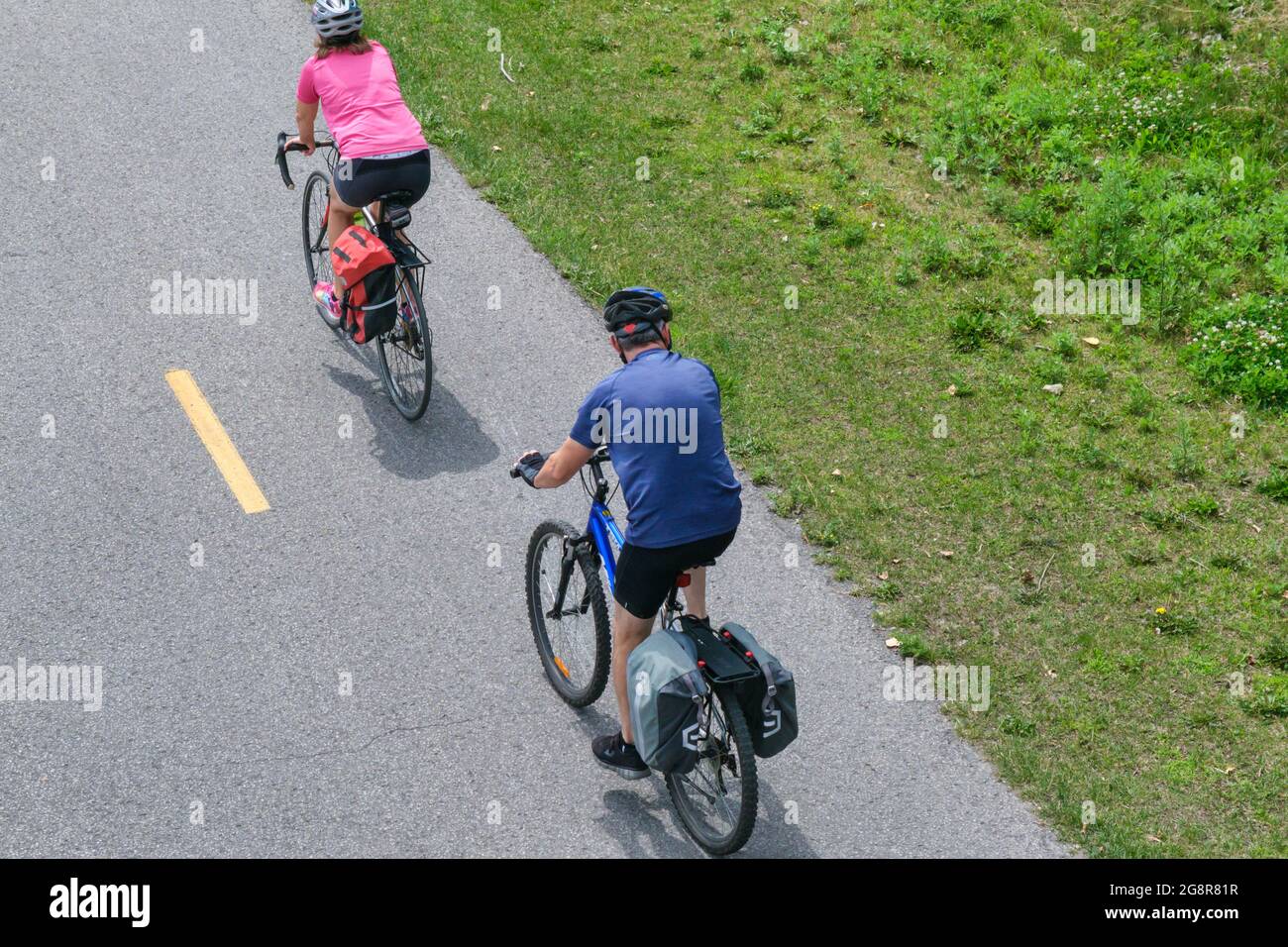 Montreal, CA - 4 July 2021: People riding bikes on Lachine Canal’s bike path Stock Photo